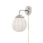 Vägglampa Marit från Strömshaga med förnicklad metall och rund opalglas kupa, beige textilsladd, sedd från sidan.