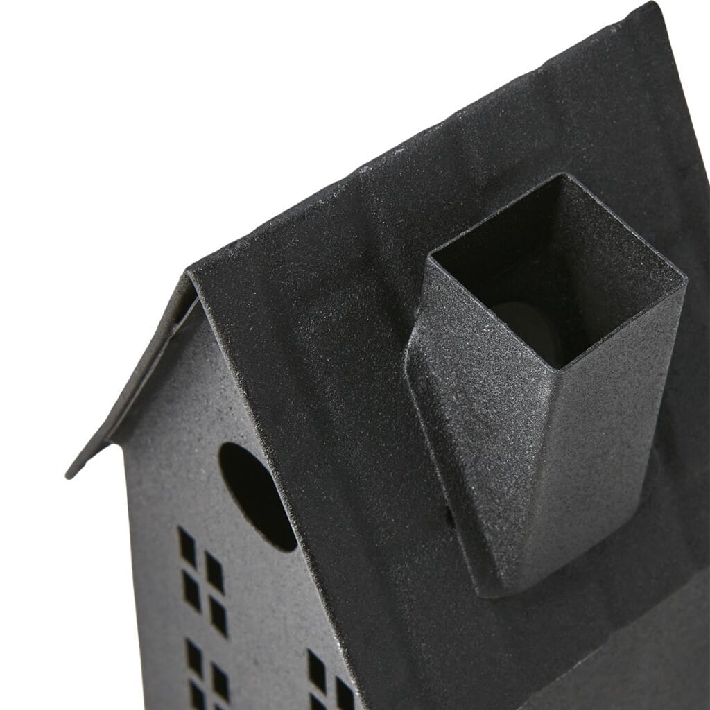 Närbild på skorstenen och taket på ljuslyktan i form av ett svart hus.