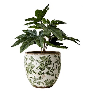 Victoria-krukan från Affari of Sweden, fylld med en grön växt. Krukan har en vit och grön design med blommigt mönster och en rustik, glaserad yta.